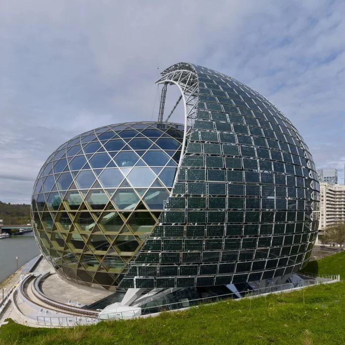 a glass dome building with a curved roof